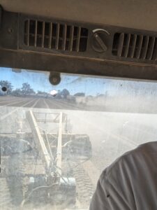 Mark Freeman in his tractor with a landplane doing preparatory work to plant alfalfa at the farm